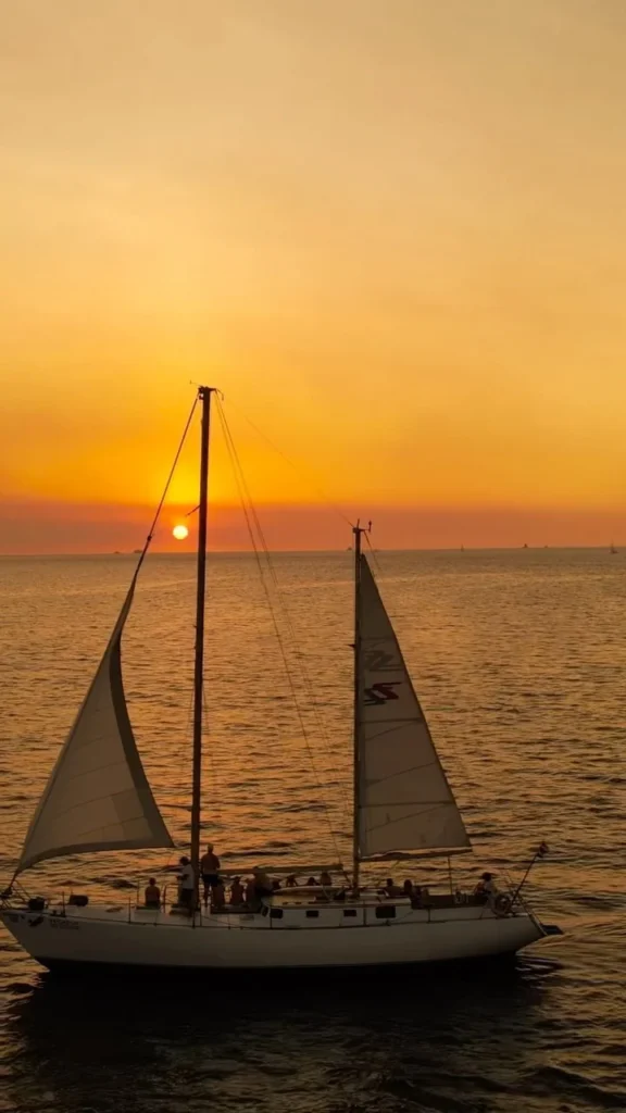 Pegasus with raised sails silhouetted against an orange sunset