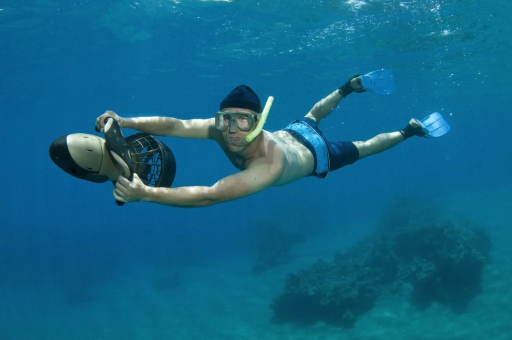 Snorkeler using an underwater sea scooter
